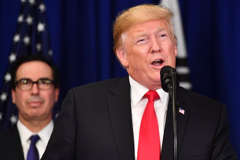 President Donald Trump speaks after a bilateral meeting as Treasury Secretary Steven Mnuchin looks on in New York on September 24, 2018.